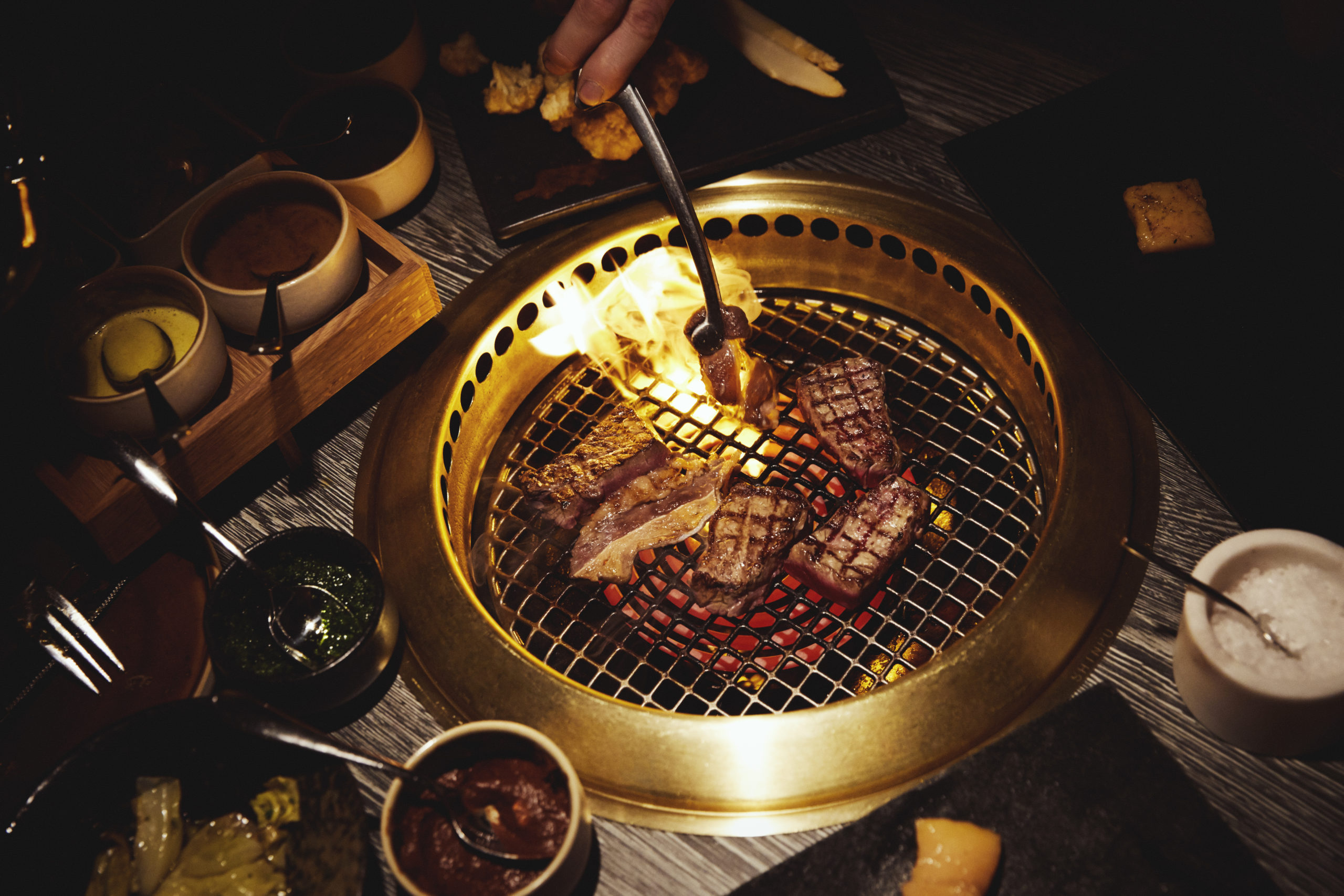 Japanese table grills with meat at Jonathan Grill