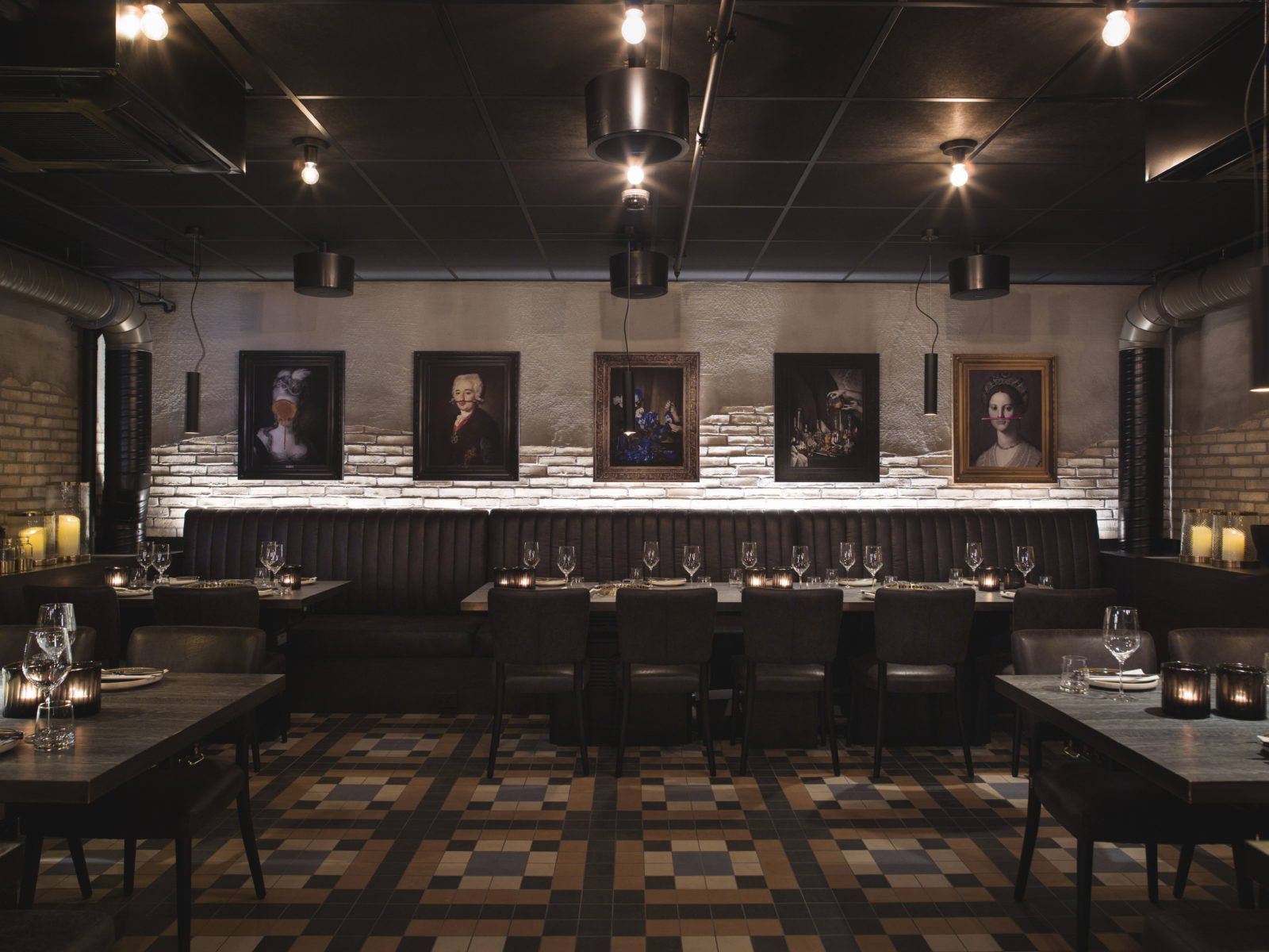The basement of Jonathan Grill with dining tables and walls decorated with paintings