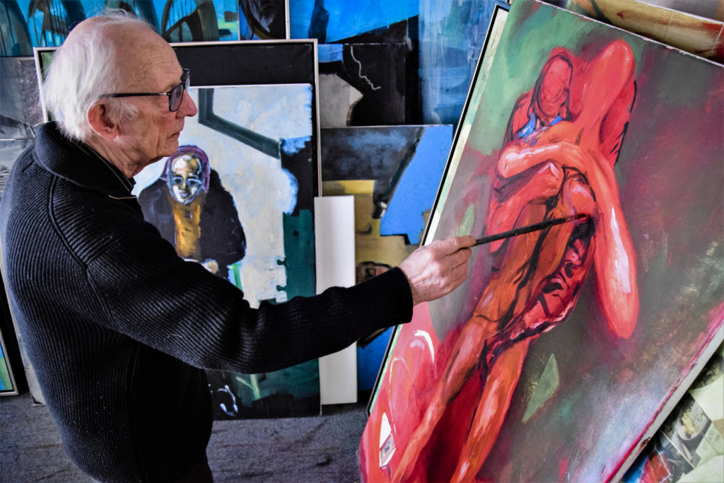 Artist Håkon Bleken painting in his studio