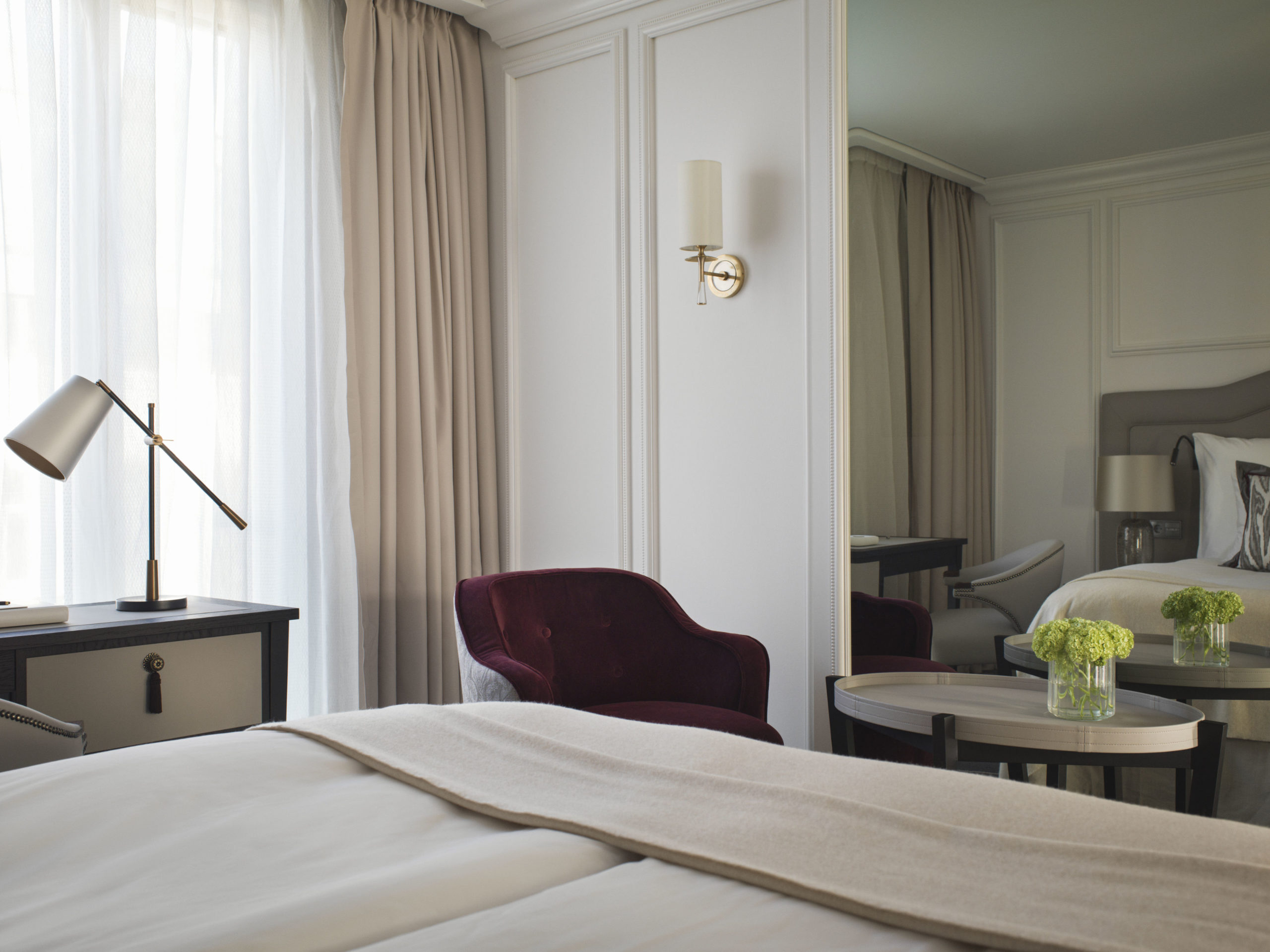 A superior room with comfortable Hästens bed, an office desk, lounge chair and coffee table