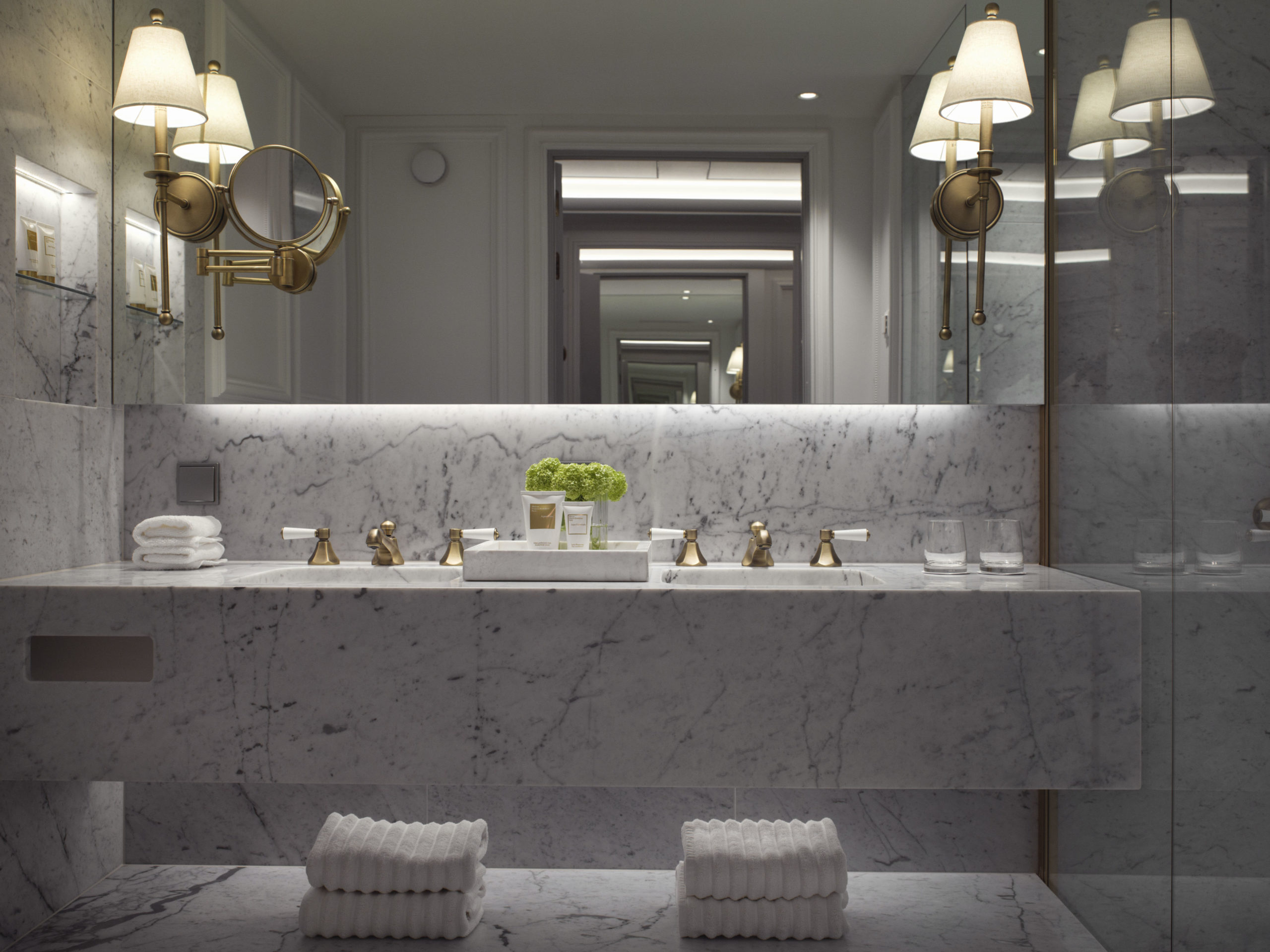 Carrara marble bathroom with white and gold interior details