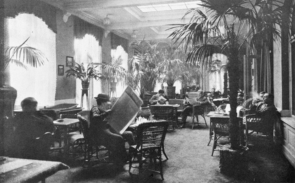 Historic black and white photo of people reading broadsheet newspapers in Britannia