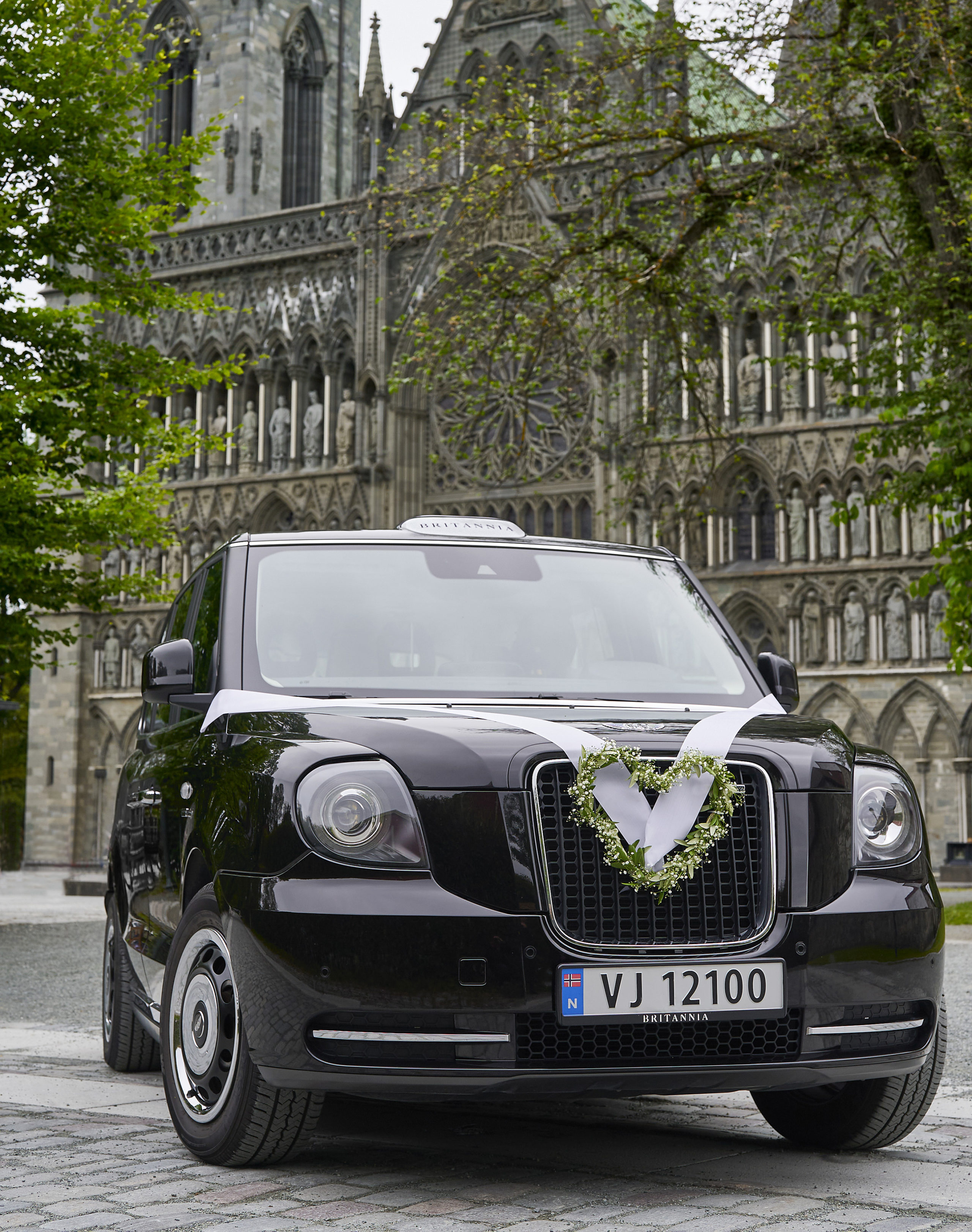 Britannia Hotel electric London black cab, decorated for a wedding, pictured outside Nidaros Cathedral in Trondheim
