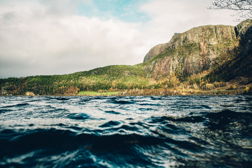 A scene of a mountain above a body of water, in Fosen, on the opposite side of the Trondheim Fjord