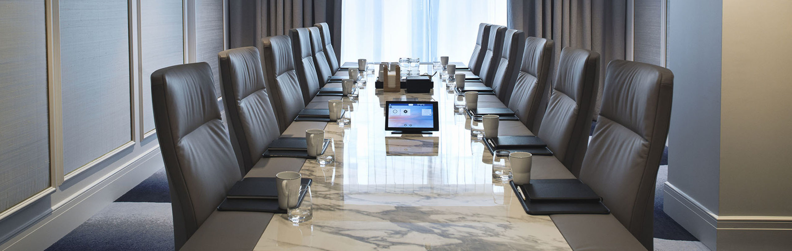 Blanka meeting room with long marble table and conference chairs