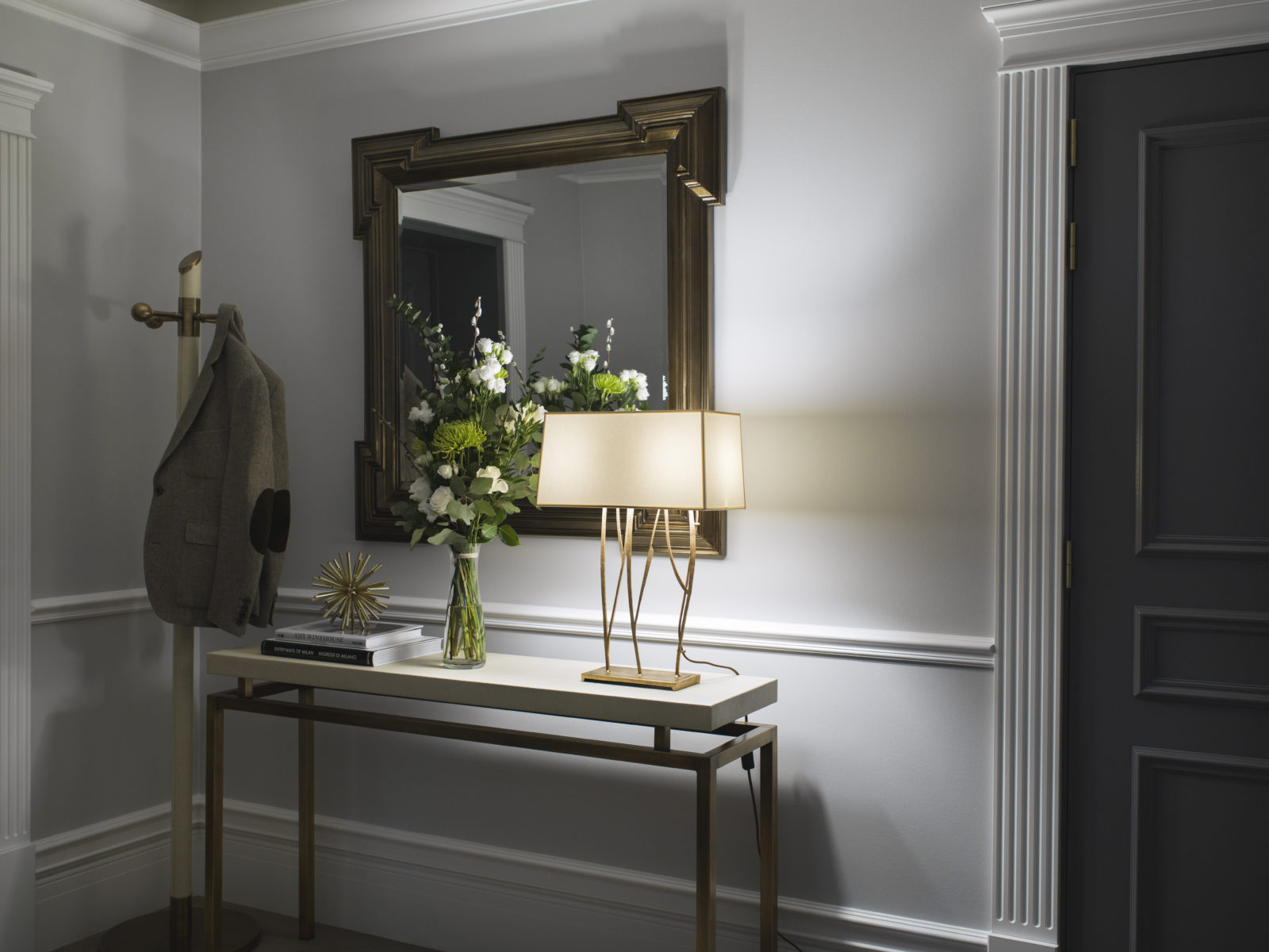 Hallway entrance with a console table, lamp and luxurios interior details