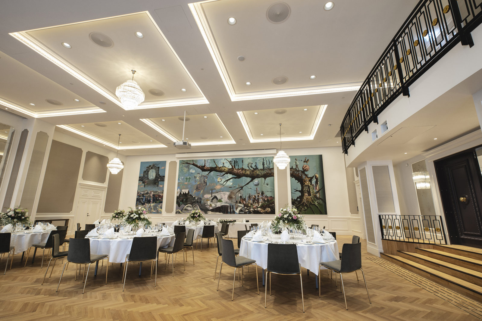 Britannia Hall with high ceiling, fine details, beautiful artwork and rounded table seating