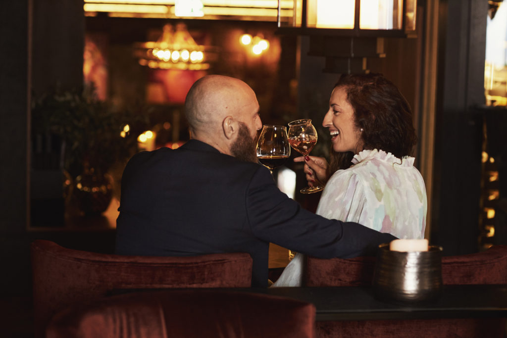 Couple enjoying glasses of wine and cocktails in Britannia's wine bar, Vinbaren