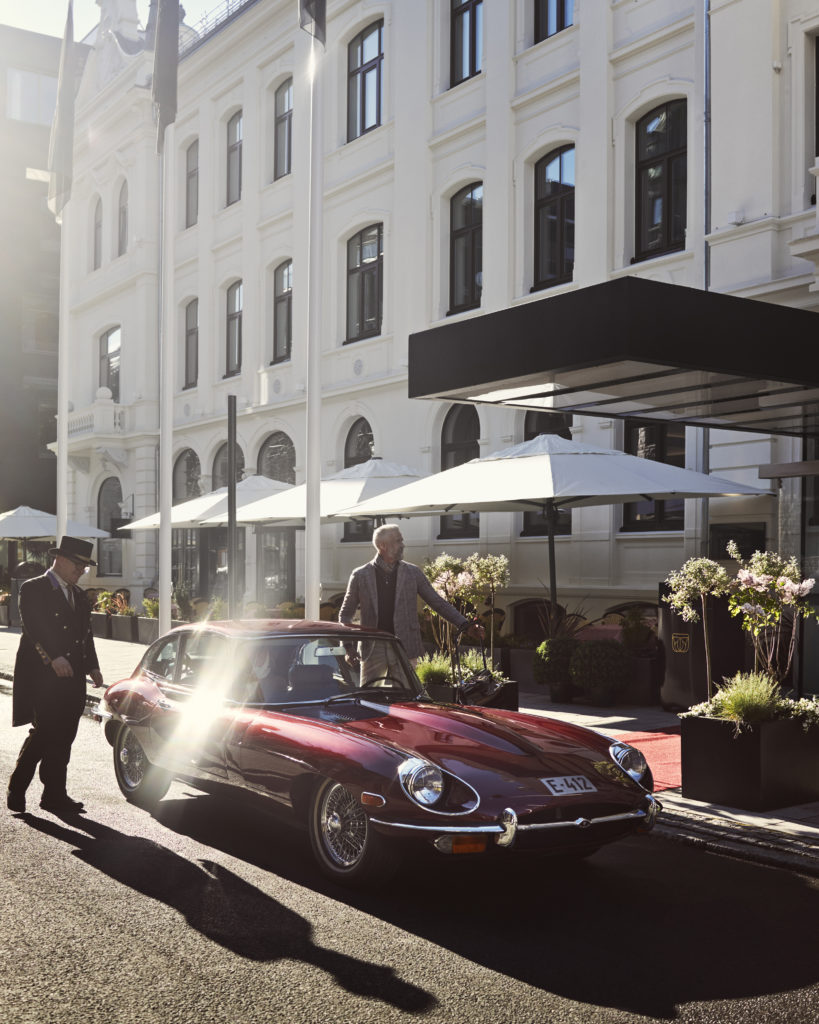 man arriving at Britannia Hotel in classic car